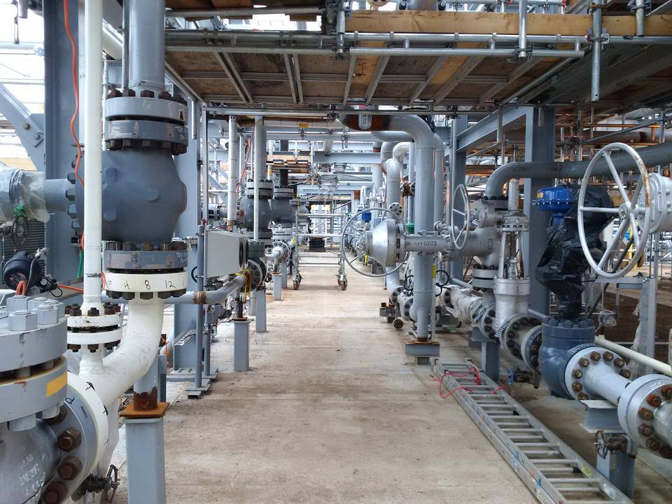 Industrial pipe rack and valve installation on a Canadian trades worksite